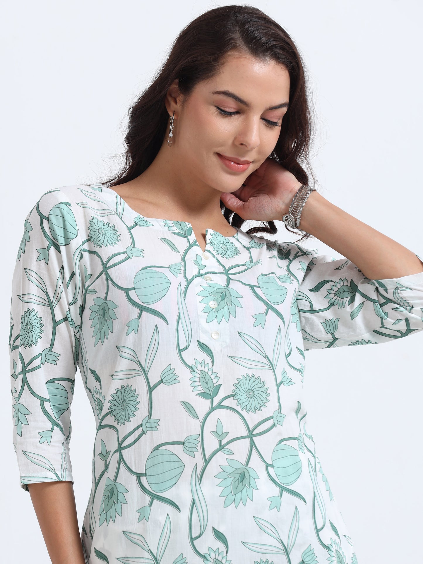 Close-up of floral pattern on the Cyan Kurti Set, featuring intricate detailing on a cool cyan background.